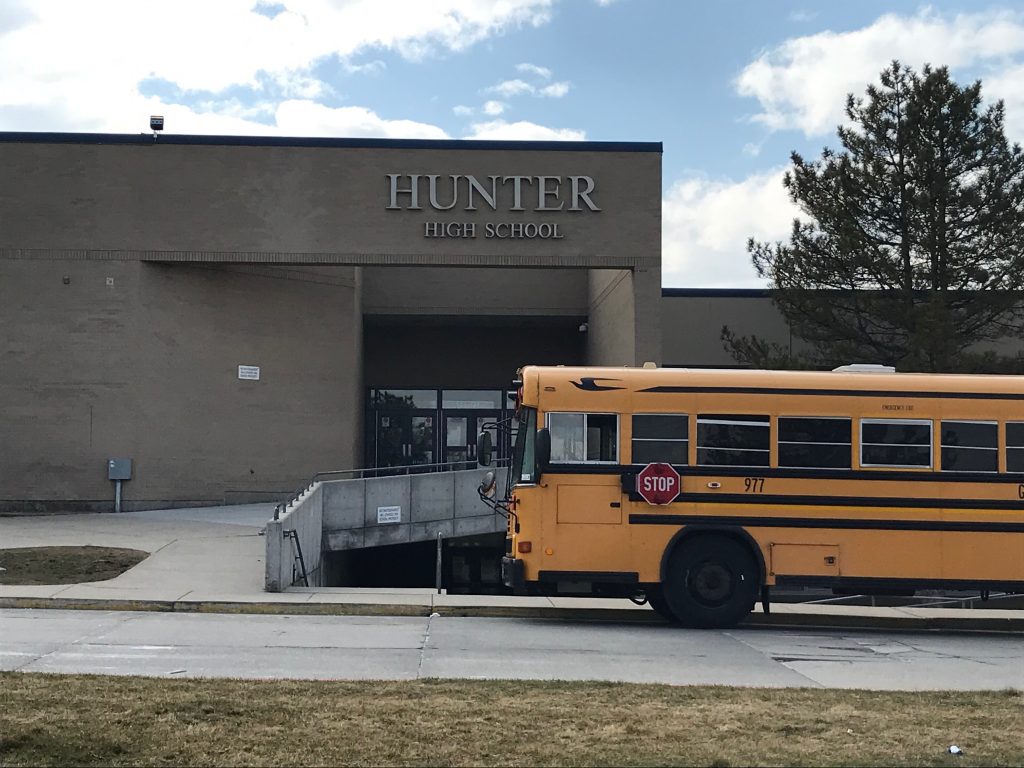 Hunter High School with a bus parked in front