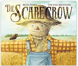 A scarecrow standing in a field with a baby crow on it's arm
