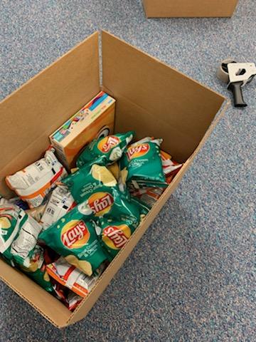 box filled with chips, cereal and other food items