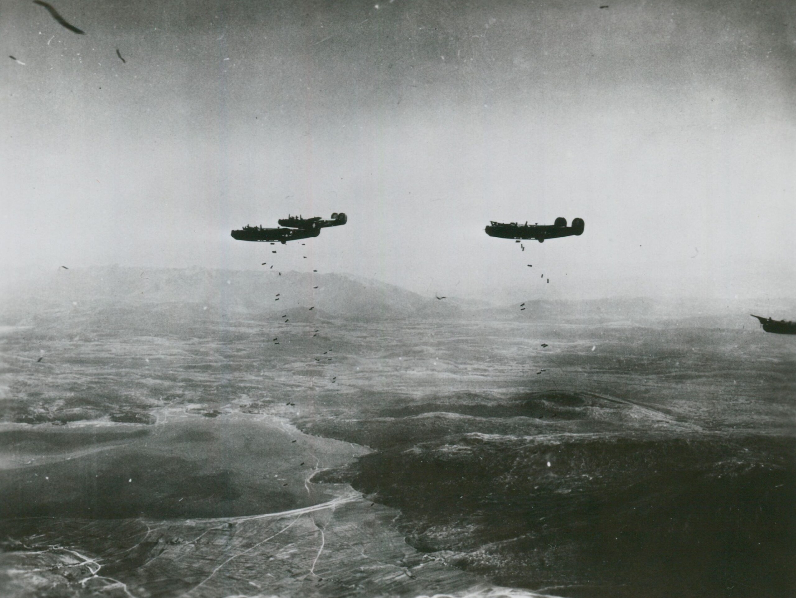 Bomber planes dropping bomb during WWII