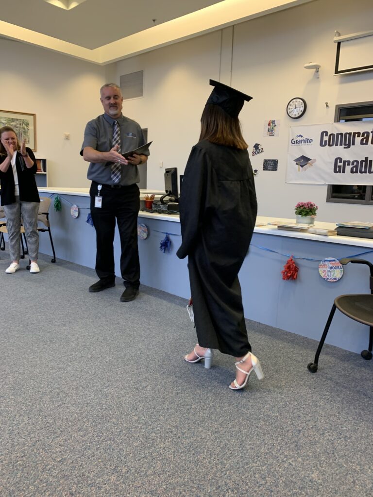 Graduate receiving diploma from principal 