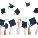 Graduates holding and throwing caps