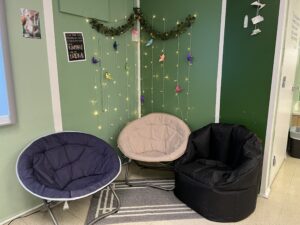 Reading corner for students with comfortable chairs and lighting.
