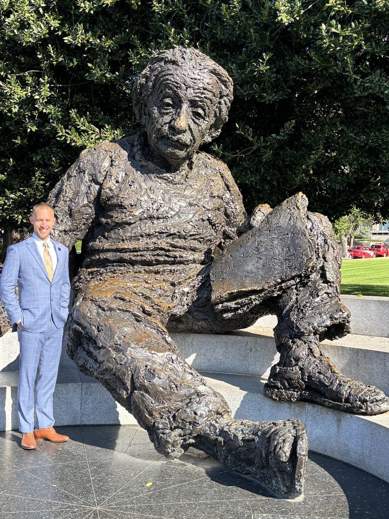 Picture of Tucker Marsing with a statue of Einstein